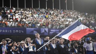 France's paralympic flag bearer Nantenin Keita, France's paralympic flag bearer Alexis Hanquinquant and France's delegation arrive during the Parade of Nations as part of the Paris 2024 Paralympic Games Opening Ceremony at the Place de la Concorde in Paris on August 28, 2024. (Photo by JULIEN DE ROSA / POOL / AFP)
