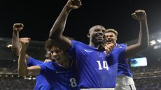 France's Jean-Philippe Mateta (14) celebrates with teammates after scoring his side's 2nd goal in extra time during the men's semifinal soccer match between France and Egypt, at Lyon Stadium, during the 2024 Summer Olympics, Monday, Aug. 5, 2024, in Decines, France. (AP Photo/Silvia Izquierdo)
