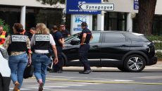 French judicial police officers walk past firefighters following a fire and explosion of cars at a synagogue in La Grande-Motte, south of France, on August 24, 2024. At least two cars, one containing a gas bottle, were set alight on the morning of August 24, 2024, in front of the synagogue in La Grande-Motte, causing an explosion that injured a local policeman, the French gendarmerie and the town's mayor said. (Photo by Pascal GUYOT / AFP)